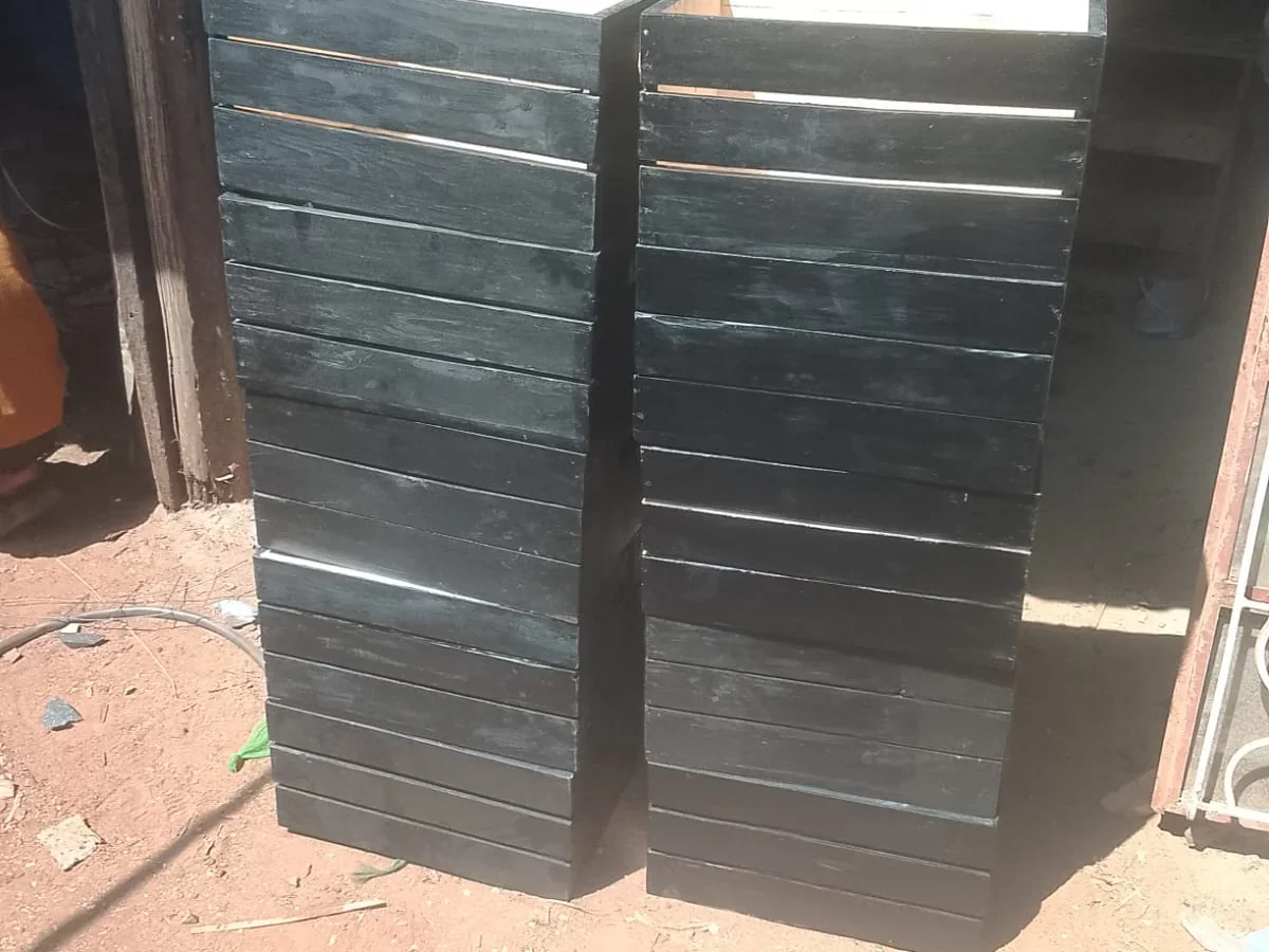 Pair of black finished wooden vertical planter crates standing outdoors