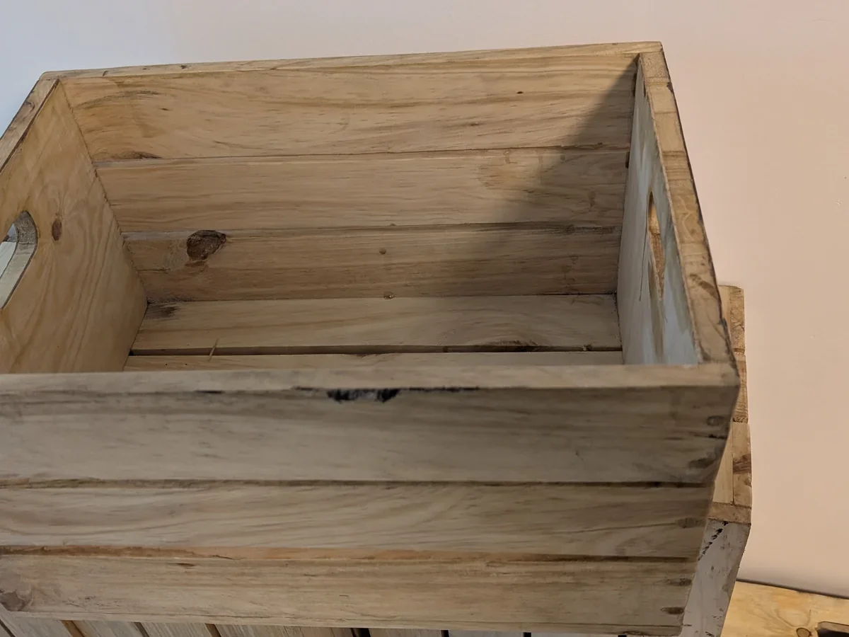 Rustic wooden display crates in natural honey tone on a workshop surface