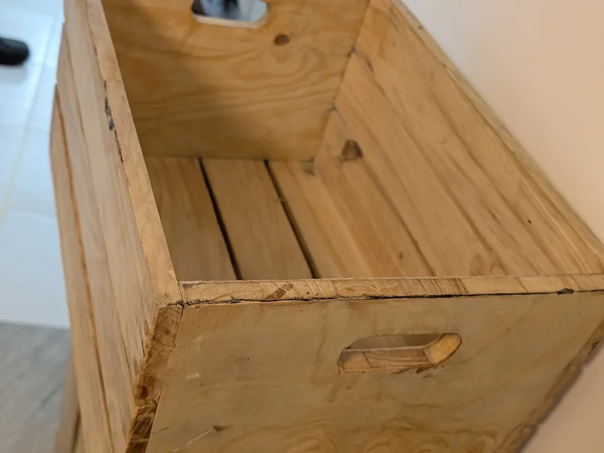 Close-up of pine wood slats and handhold cutout in interior home setting